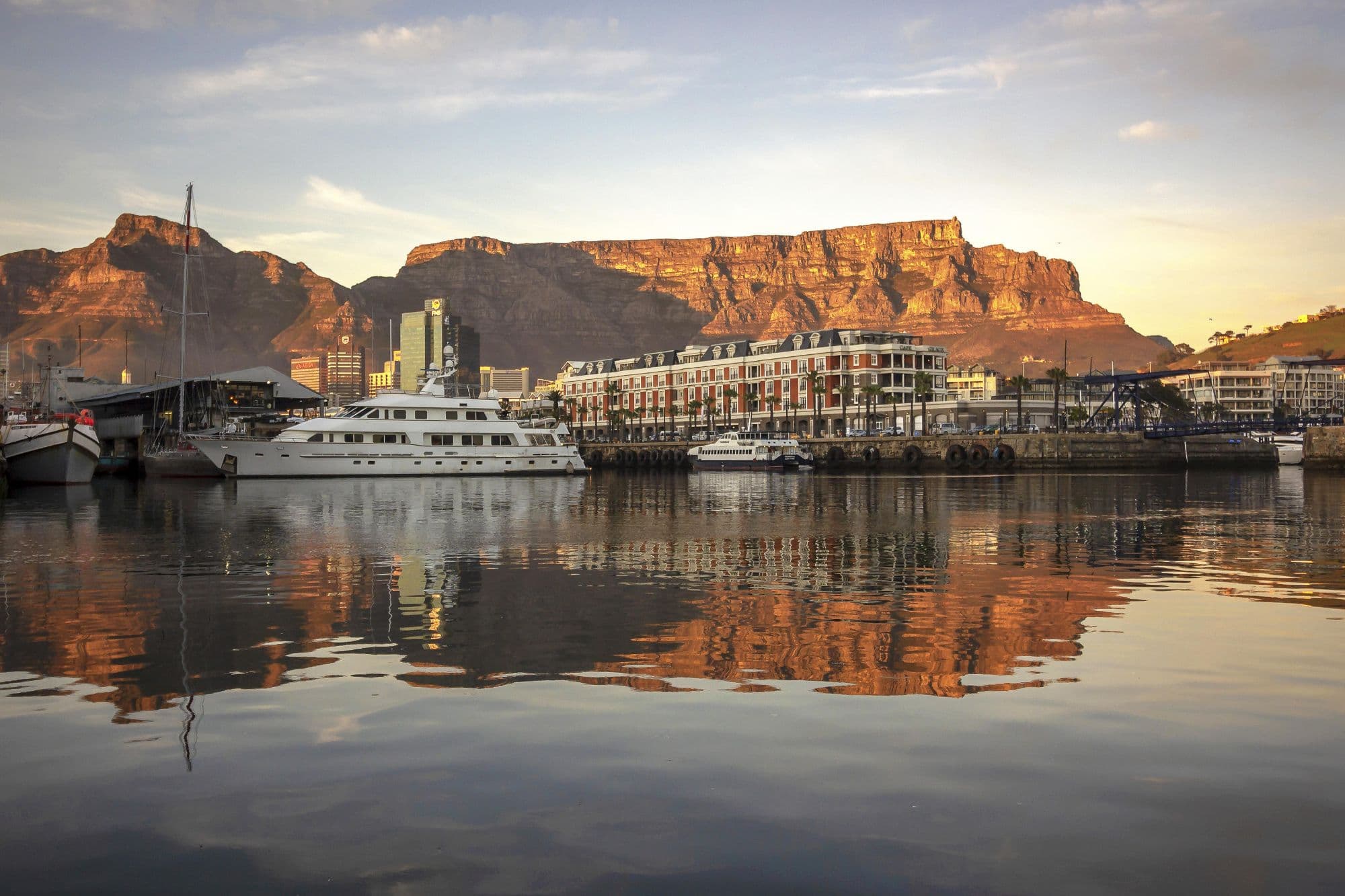 The V&A Waterfront at sunset — Table Mountain and Cape Grace reflected in the harbour