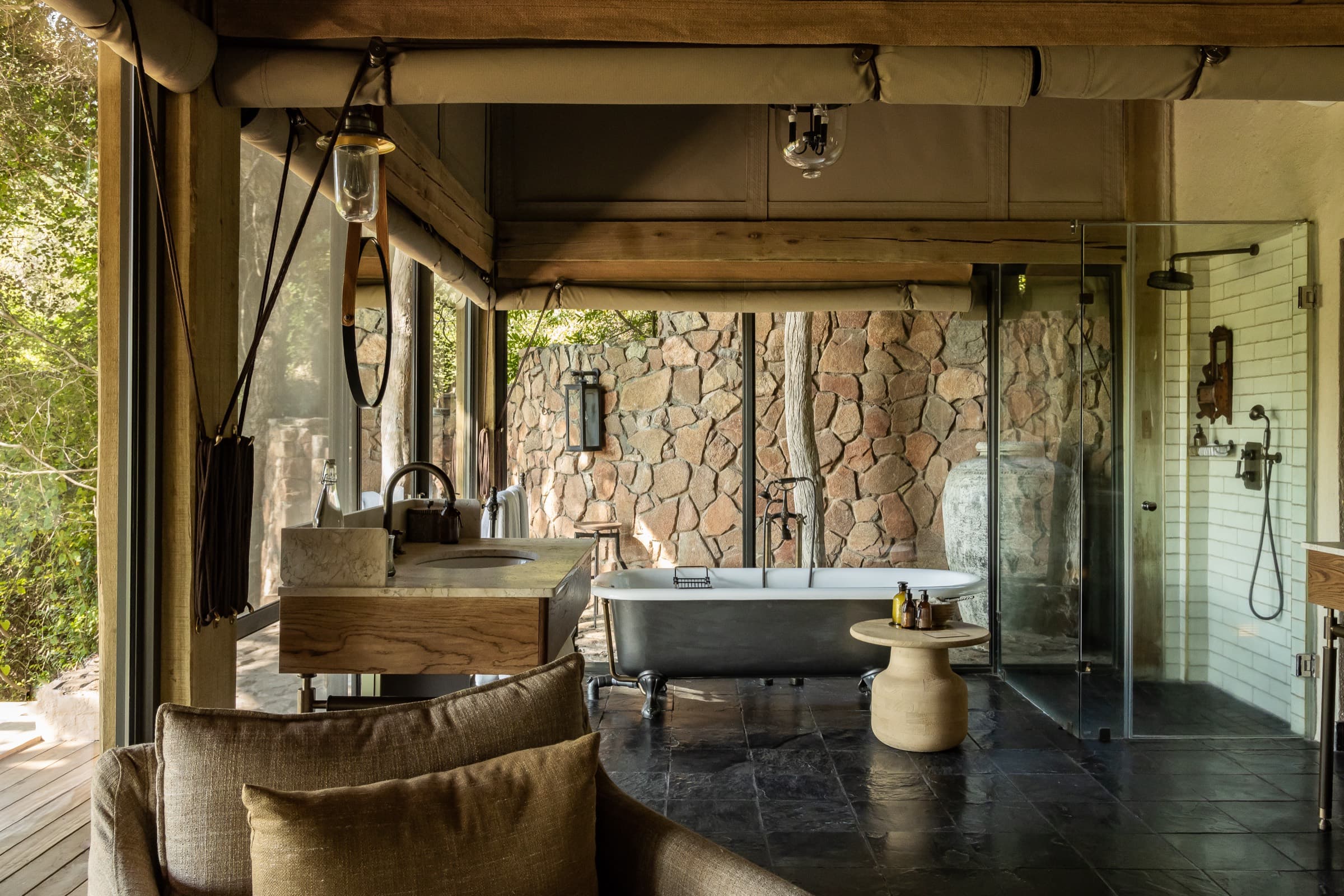 An Ebony suite bathroom in stone, open to the riverine bush